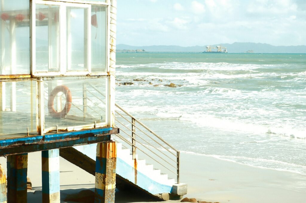 Stairs down from a beachfront deck to the surf