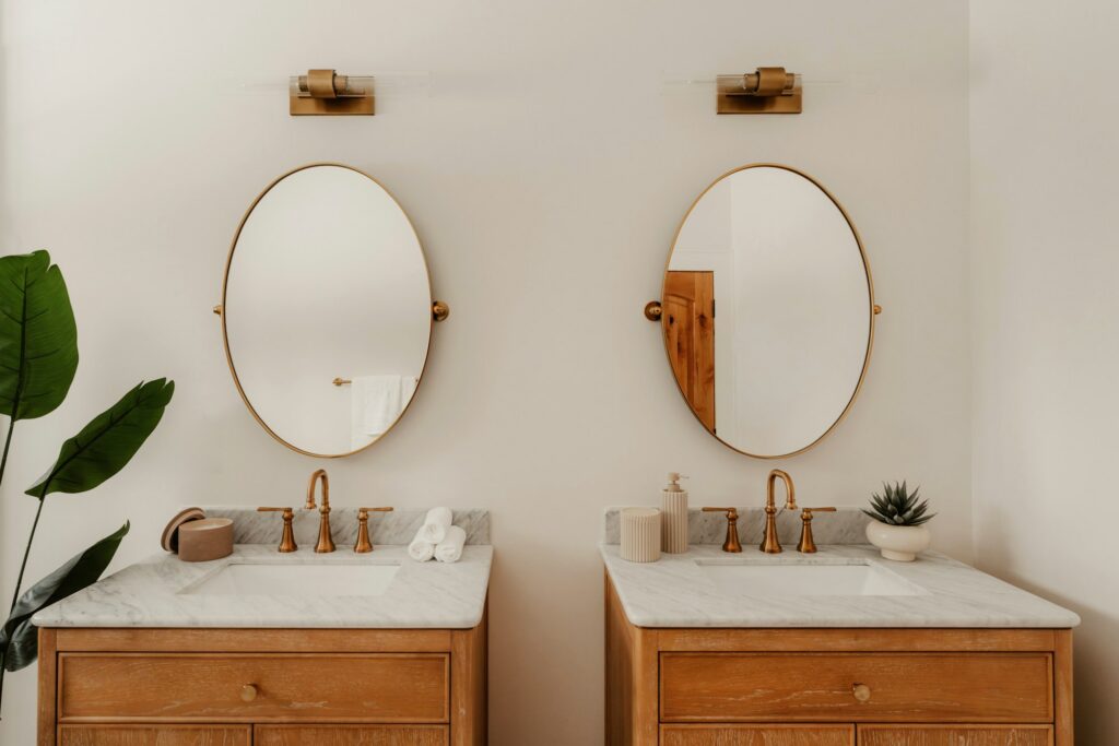 Twin vanities with oval mirrors