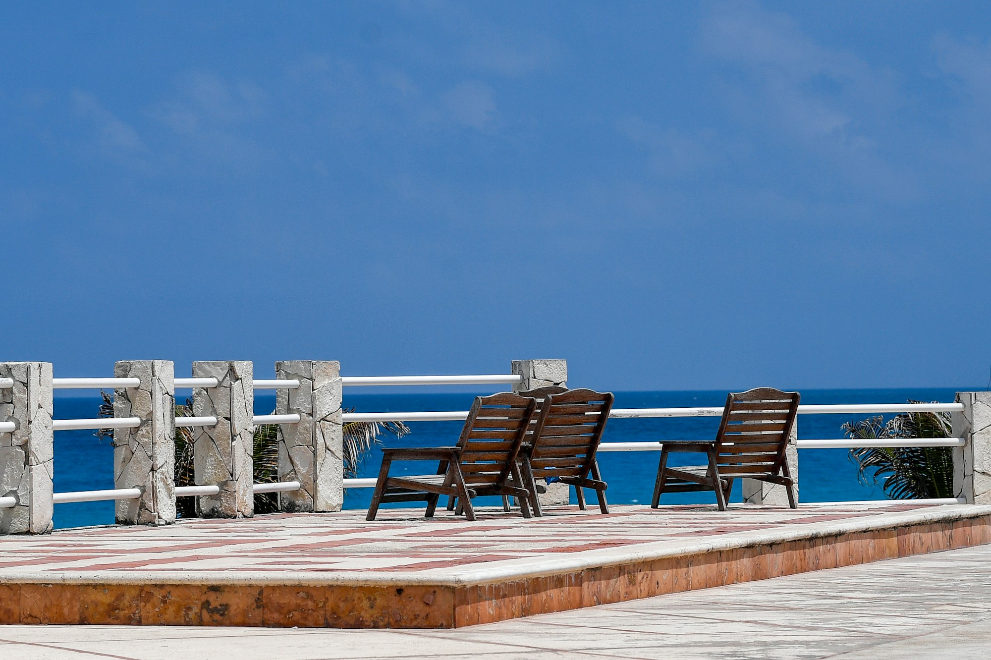 Two chairs on the deck facing the water