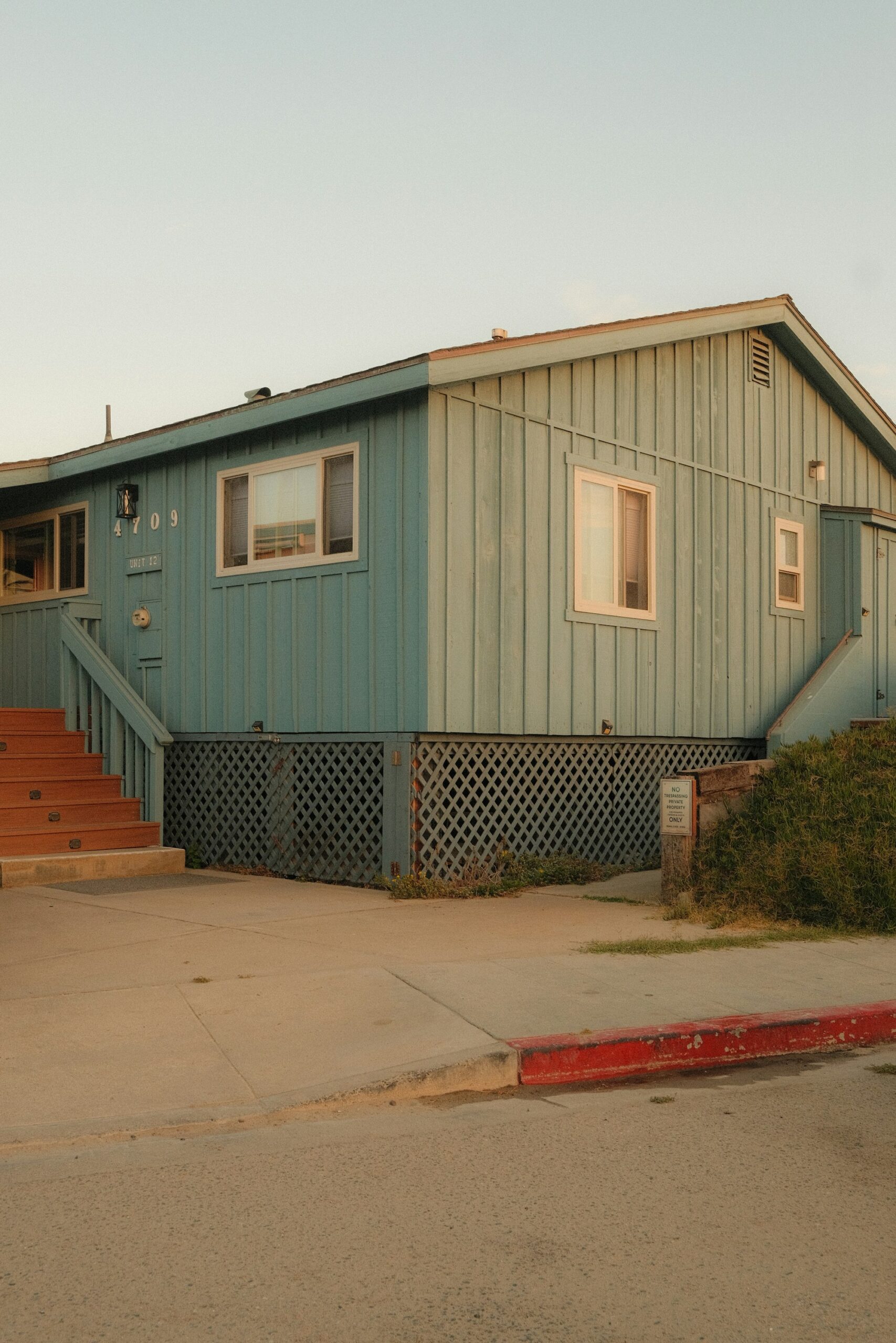 A raised coastal cottage in sea-glass green