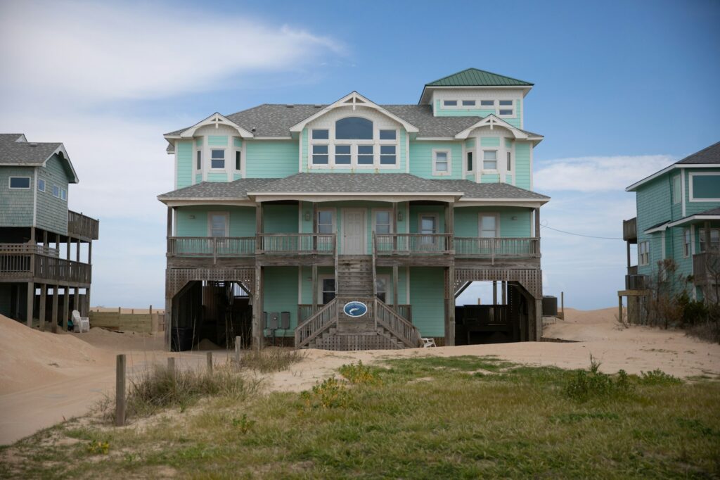 A raised beach house on pilings with wraparound porches