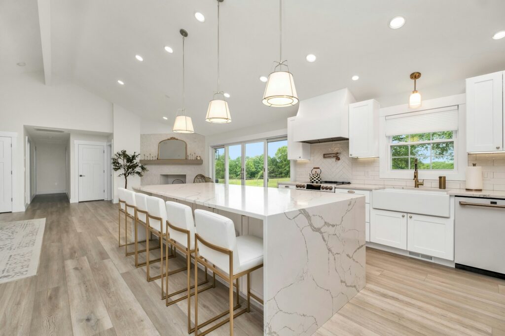 White kitchen with a long marble island