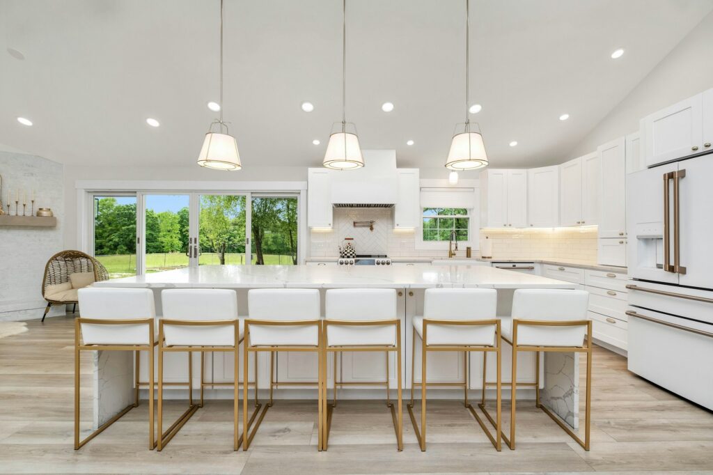 Island with counter seating under pendant lights
