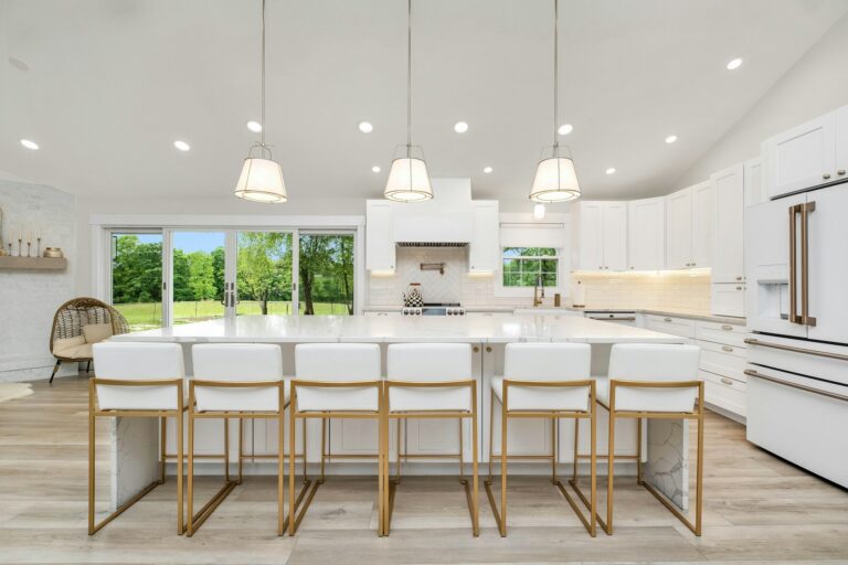 Island with counter seating under pendant lights