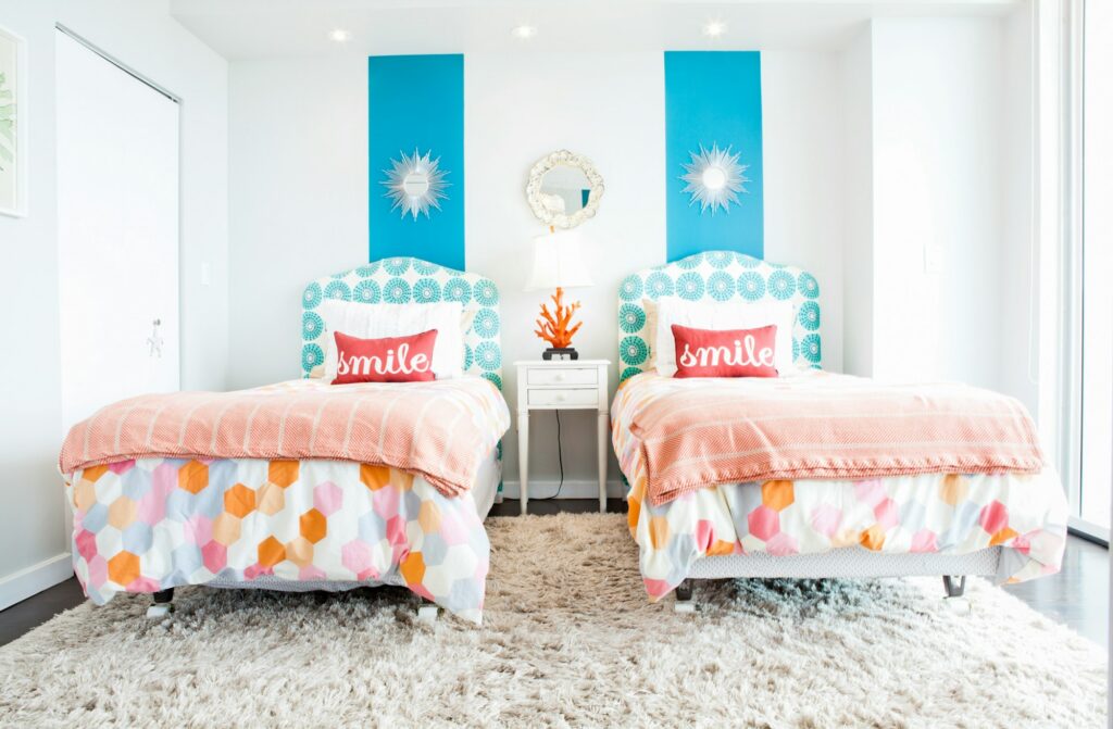 Twin beds with bright floral quilts